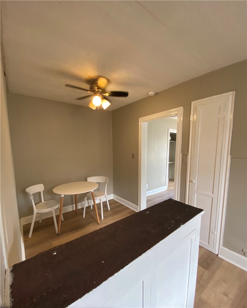 408 East 4th Street Alice, TX 78332 - Photo 8 of 14 a living room with a table chairs and a refrigerator
