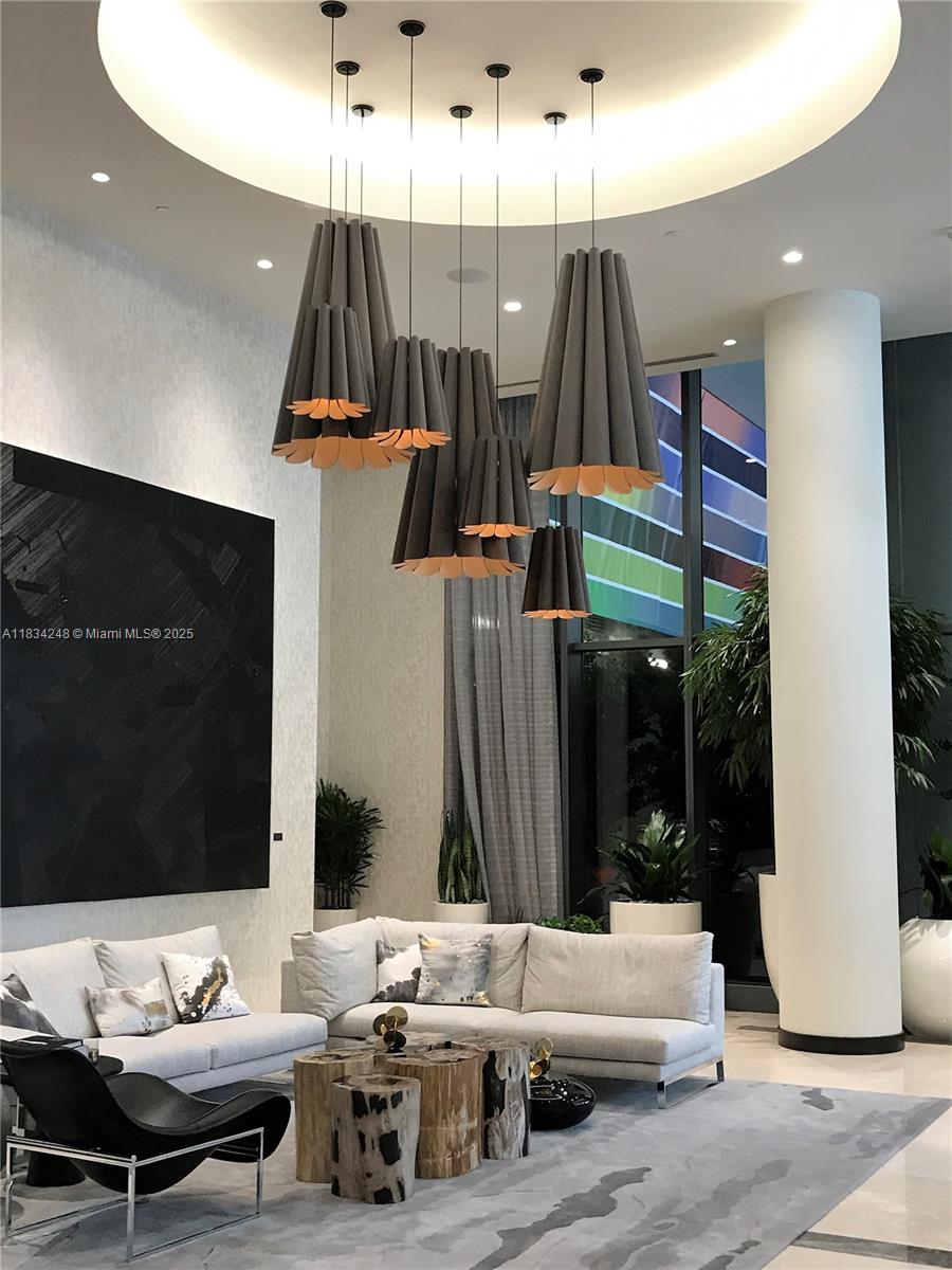 55 Southwest 9th Street, Unit 3009 Miami, FL 33130 - Photo 3 of 15 a living room with furniture and a flat screen tv