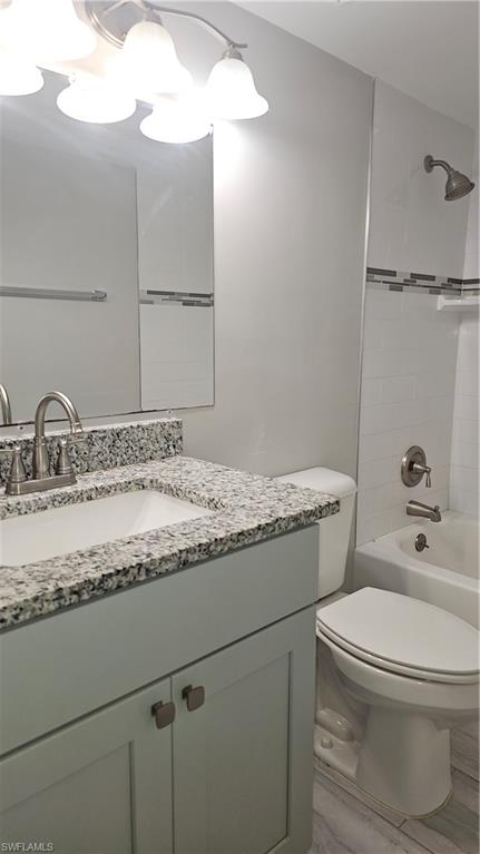 4900 Biscayne Drive, Unit 23 Naples, FL 34112 - Photo 16 of 21 Full bathroom with tiled shower / bath, vanity, and toilet