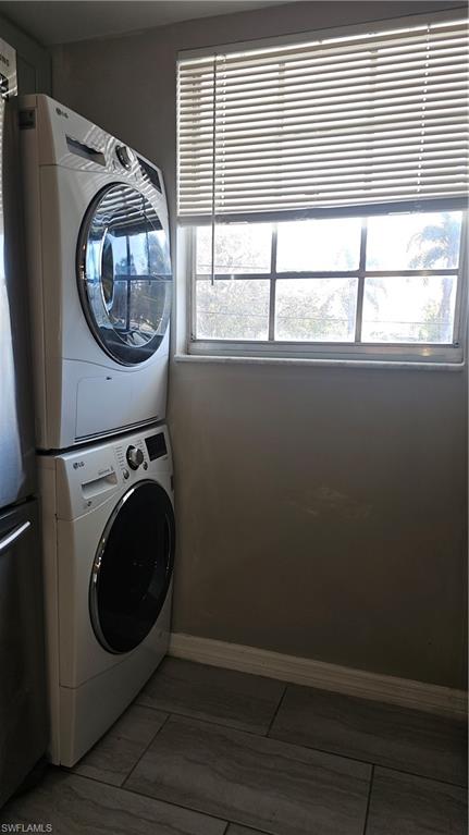 4900 Biscayne Drive, Unit 23 Naples, FL 34112 - Photo 3 of 21 Clothes washing area with stacked washing maching and dryer