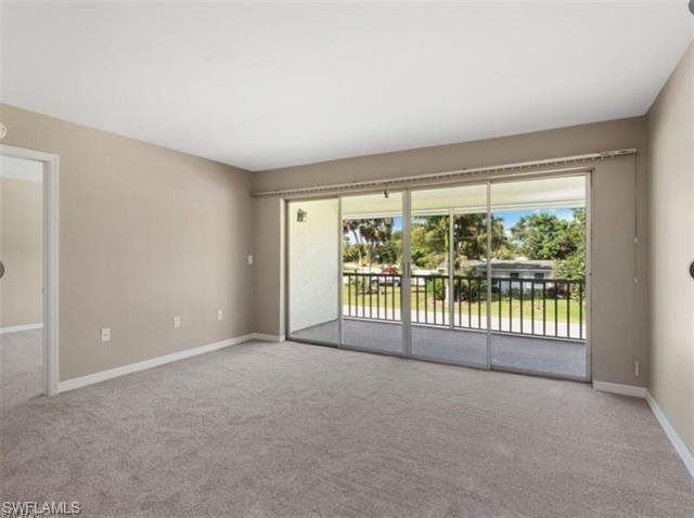 4900 Biscayne Drive, Unit 23 Naples, FL 34112 - Photo 8 of 21 Spare room with light colored carpet