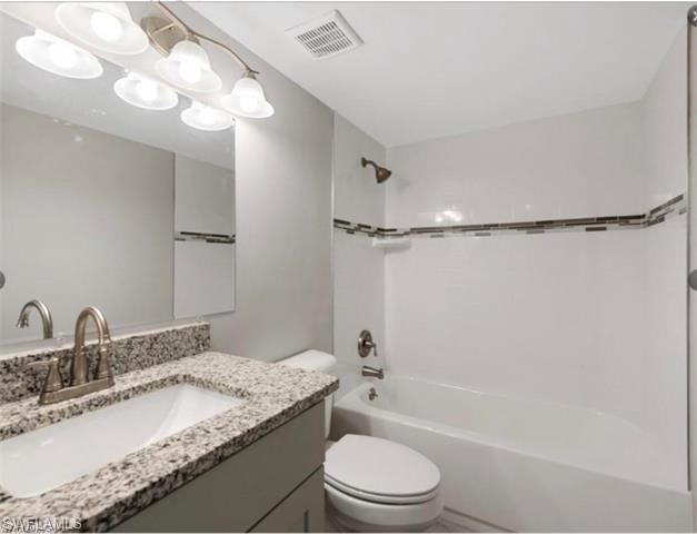 4900 Biscayne Drive, Unit 23 Naples, FL 34112 - Photo 10 of 21 Full bathroom with vanity, tiled shower / bath, and toilet