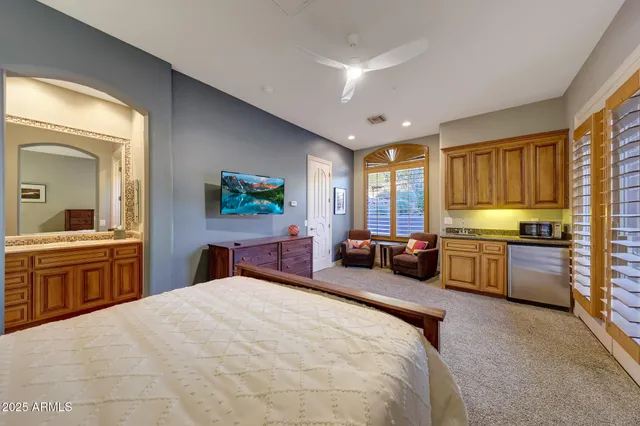 a large bedroom with a large bed and a large window