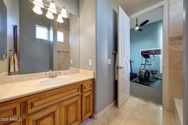 a en suite bathroom with a sink a mirror and a shower