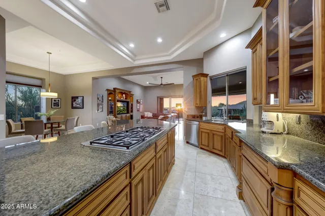 a kitchen with stainless steel appliances granite countertop sink stove and cabinets