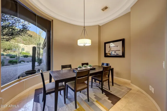 a view of a dining room with furniture window and outside view