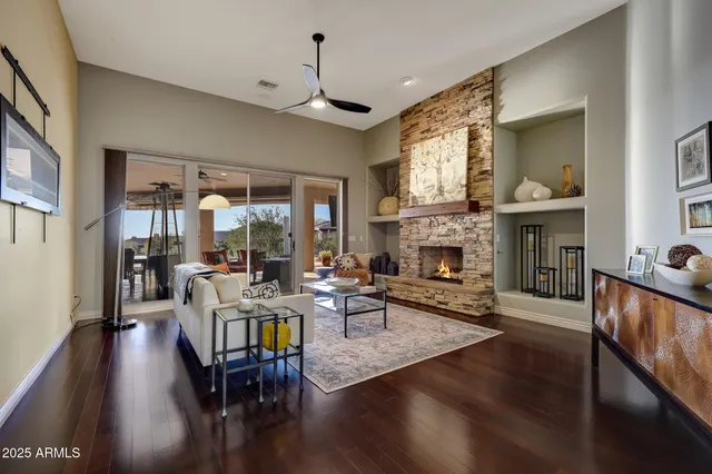 a living room with furniture fireplace and window