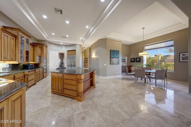 a large living room with stainless steel appliances granite countertop furniture a rug and a view