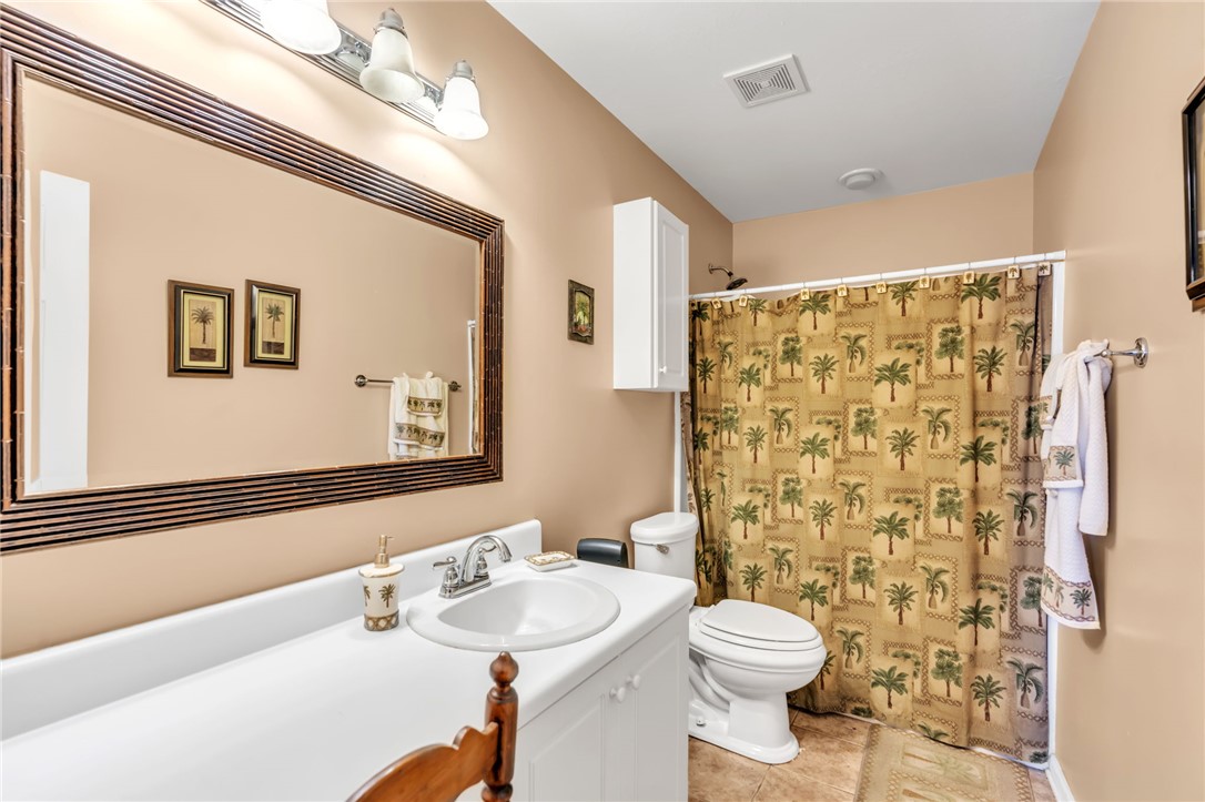 18 Sweetgrass Trail Anderson, SC 29625 - Photo 15 of 26 This bright bathroom features a spacious vanity, tiled flooring, and a shower with an accent curtain.