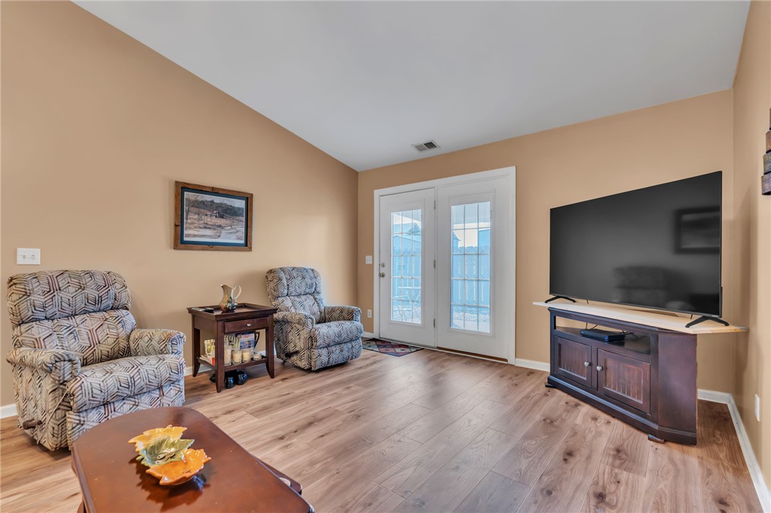18 Sweetgrass Trail Anderson, SC 29625 - Photo 6 of 26 This inviting living area features warm tones and elegant French doors, offering a welcoming atmosphere.