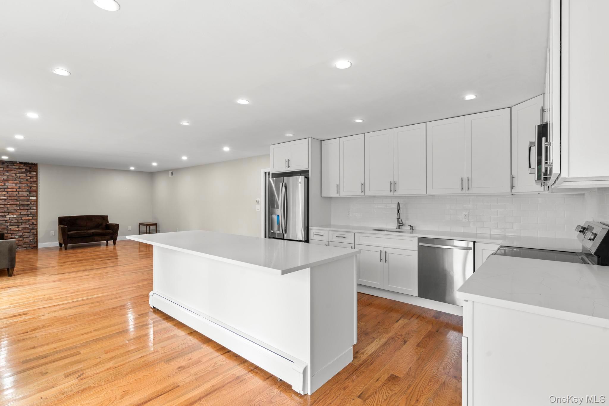 513 Bedford Road Armonk, NY 10504 - Photo 12 of 38 a kitchen with stainless steel appliances granite countertop a sink a stove a microwave and a refrigerator