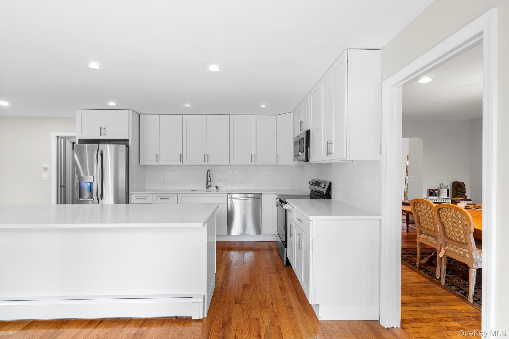 513 Bedford Road Armonk, NY 10504 - Photo 14 of 38 a kitchen with stainless steel appliances granite countertop a refrigerator sink and white cabinets