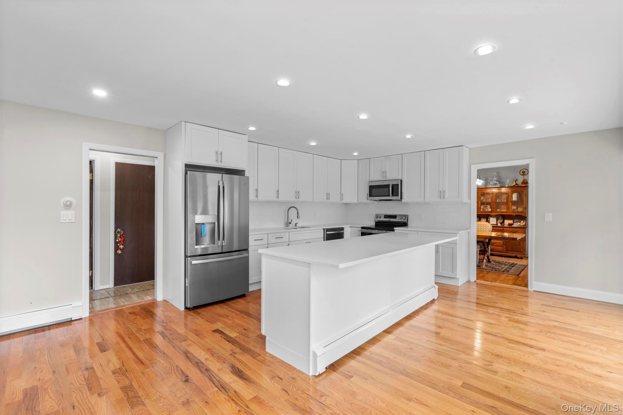 513 Bedford Road Armonk, NY 10504 - Photo 15 of 38 a large white kitchen with stainless steel appliances granite countertop a large counter top and a refrigerator