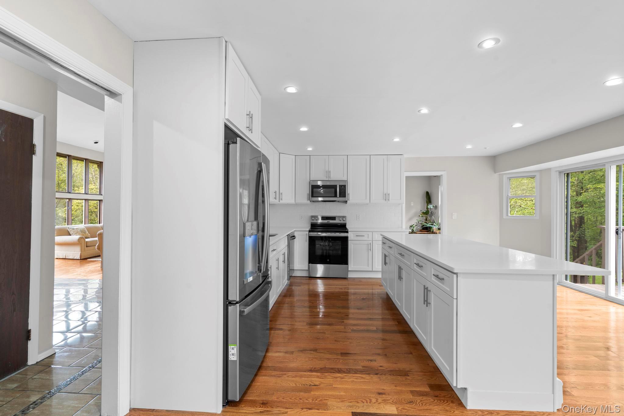 513 Bedford Road Armonk, NY 10504 - Photo 17 of 38 a large kitchen with stainless steel appliances granite countertop a refrigerator and a stove top oven