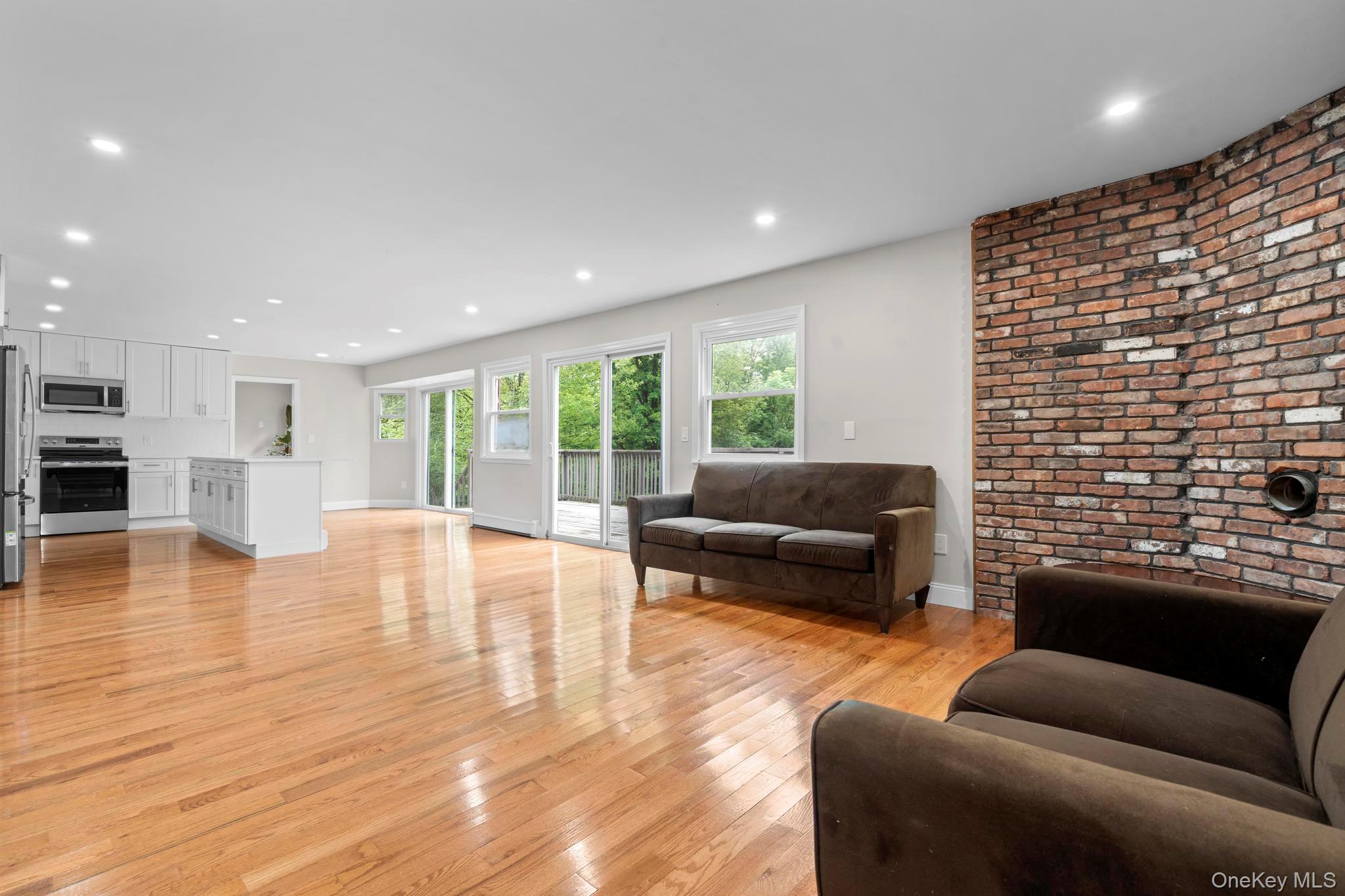 513 Bedford Road Armonk, NY 10504 - Photo 18 of 38 a living room with furniture floor to ceiling window and wooden floor