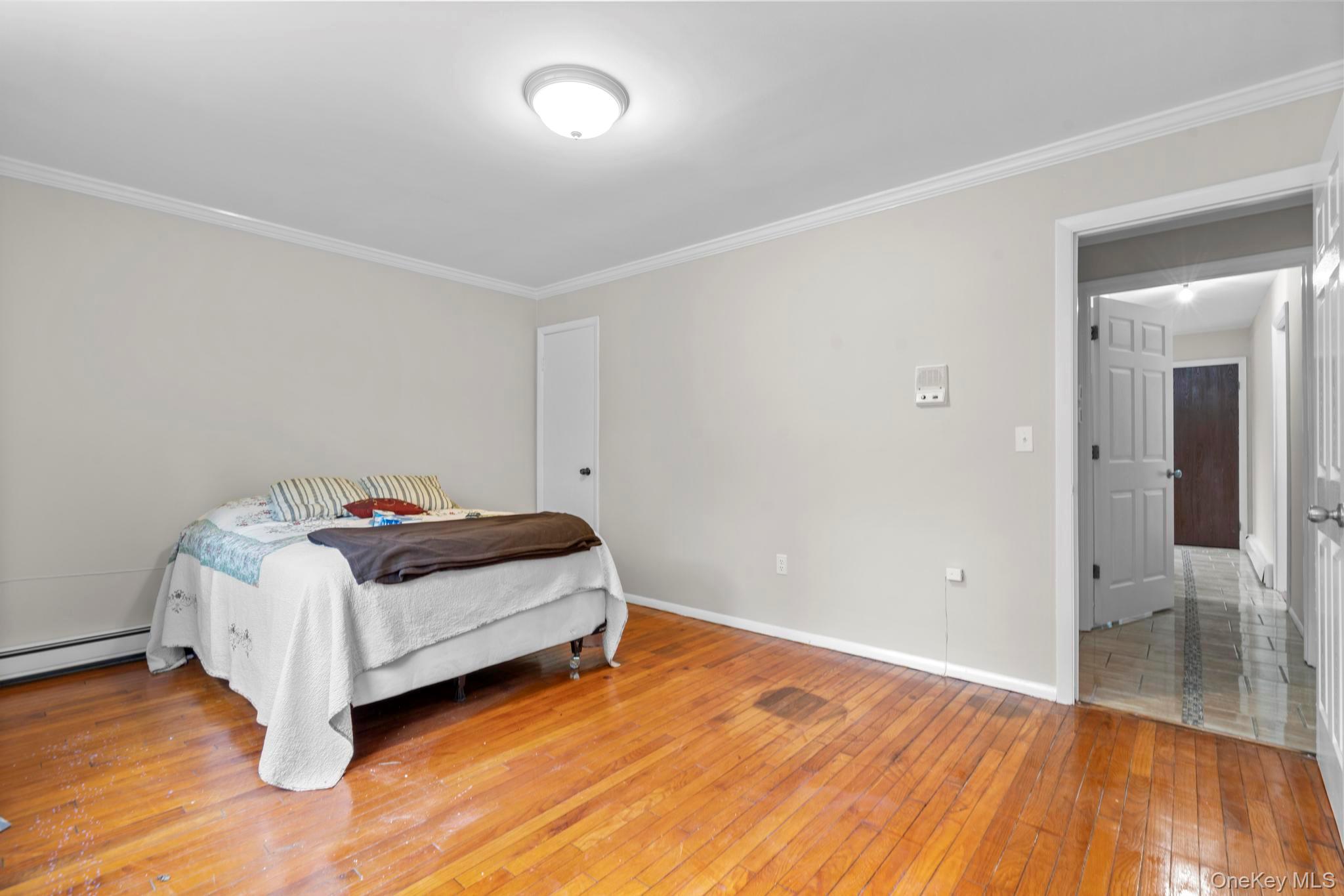 513 Bedford Road Armonk, NY 10504 - Photo 22 of 38 a room with a bed and wooden floor