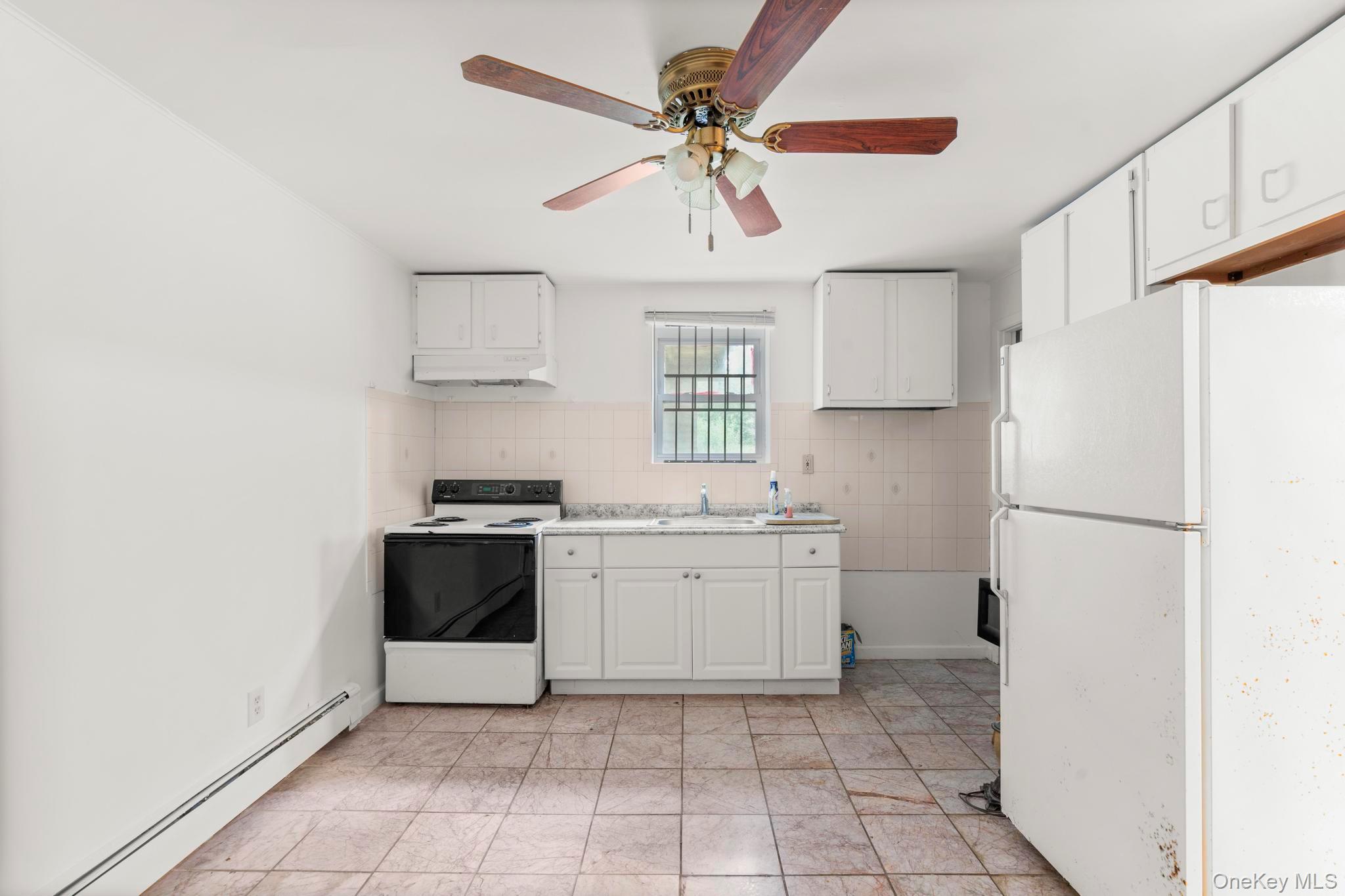 513 Bedford Road Armonk, NY 10504 - Photo 30 of 38 a kitchen with a stove a refrigerator and a sink