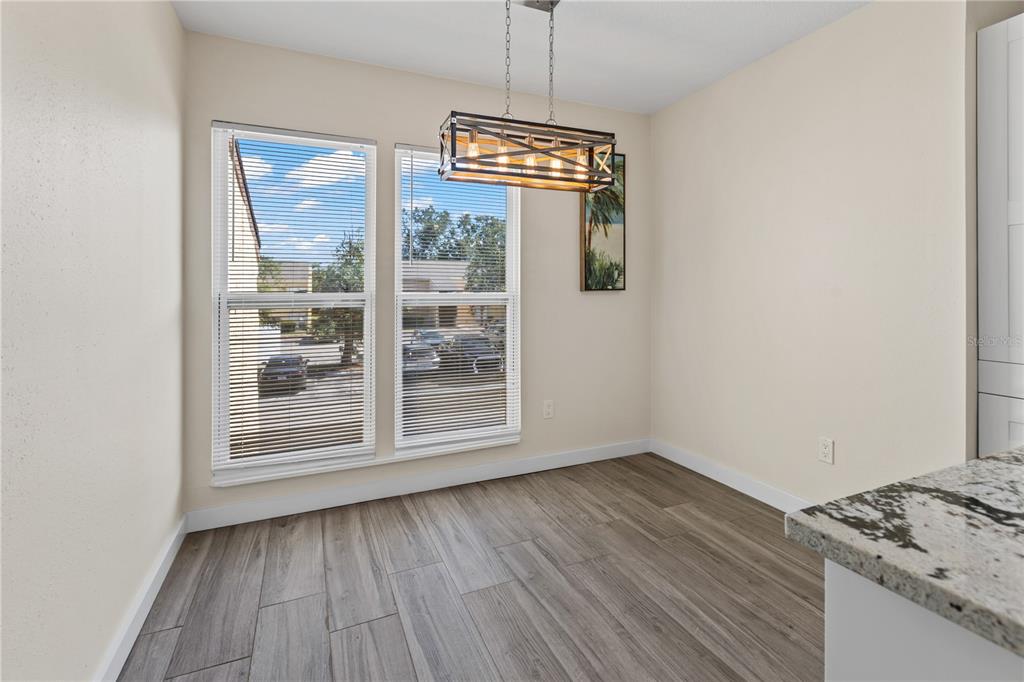 3405 Clark Road, Unit 205 Sarasota, FL 34231 - Photo 8 of 28 a view of empty room with wooden floor and fan