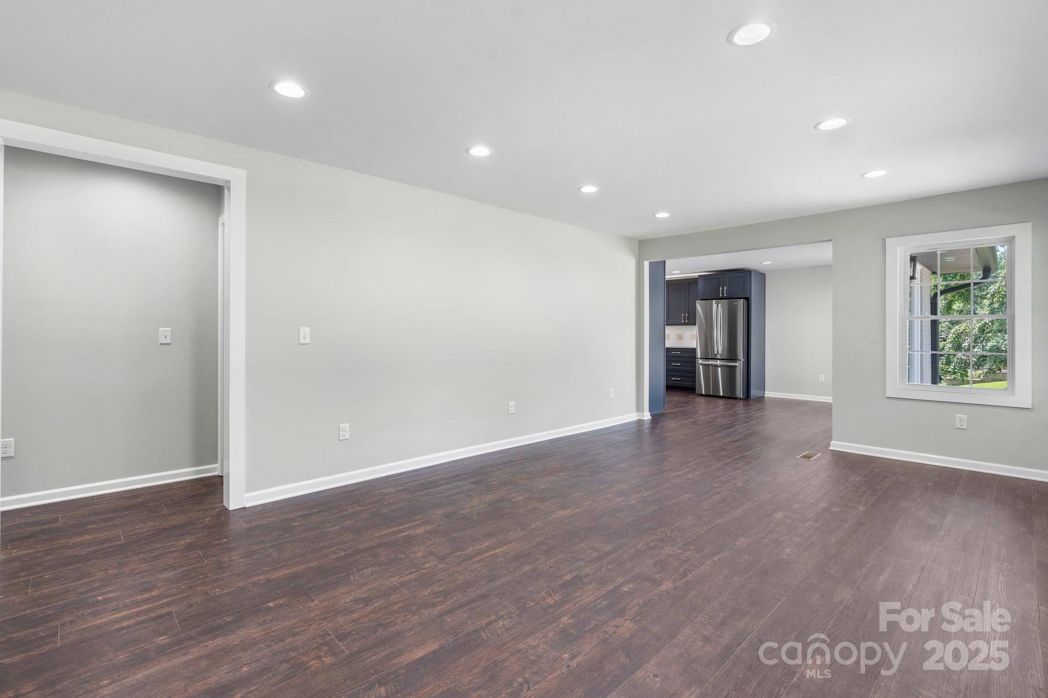 191 Harmony Grove Road Nebo, NC 28761 - Photo 18 of 47 a view of an empty room with wooden floor and a window
