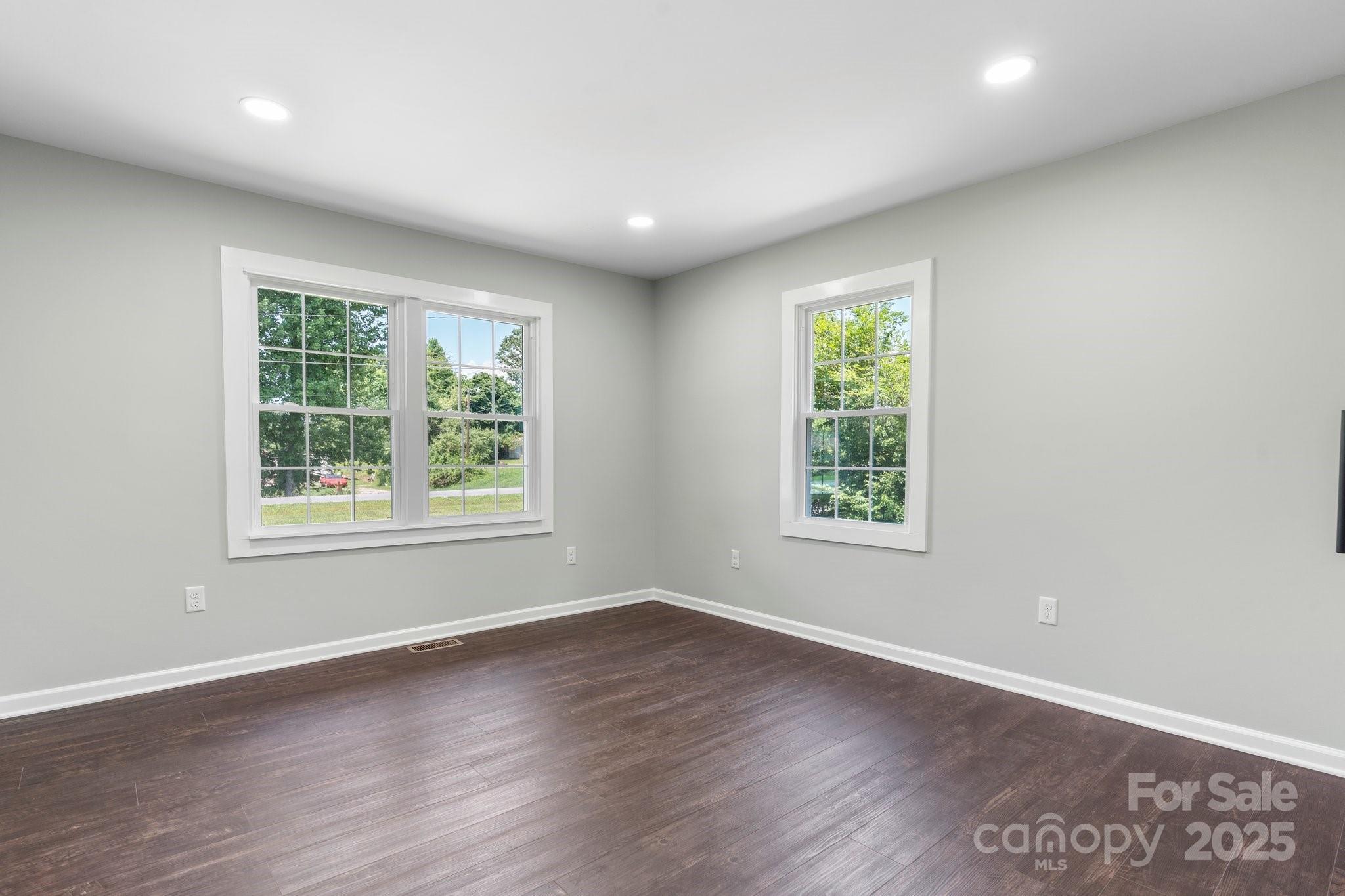 191 Harmony Grove Road Nebo, NC 28761 - Photo 21 of 47 an empty room with wooden floor and windows