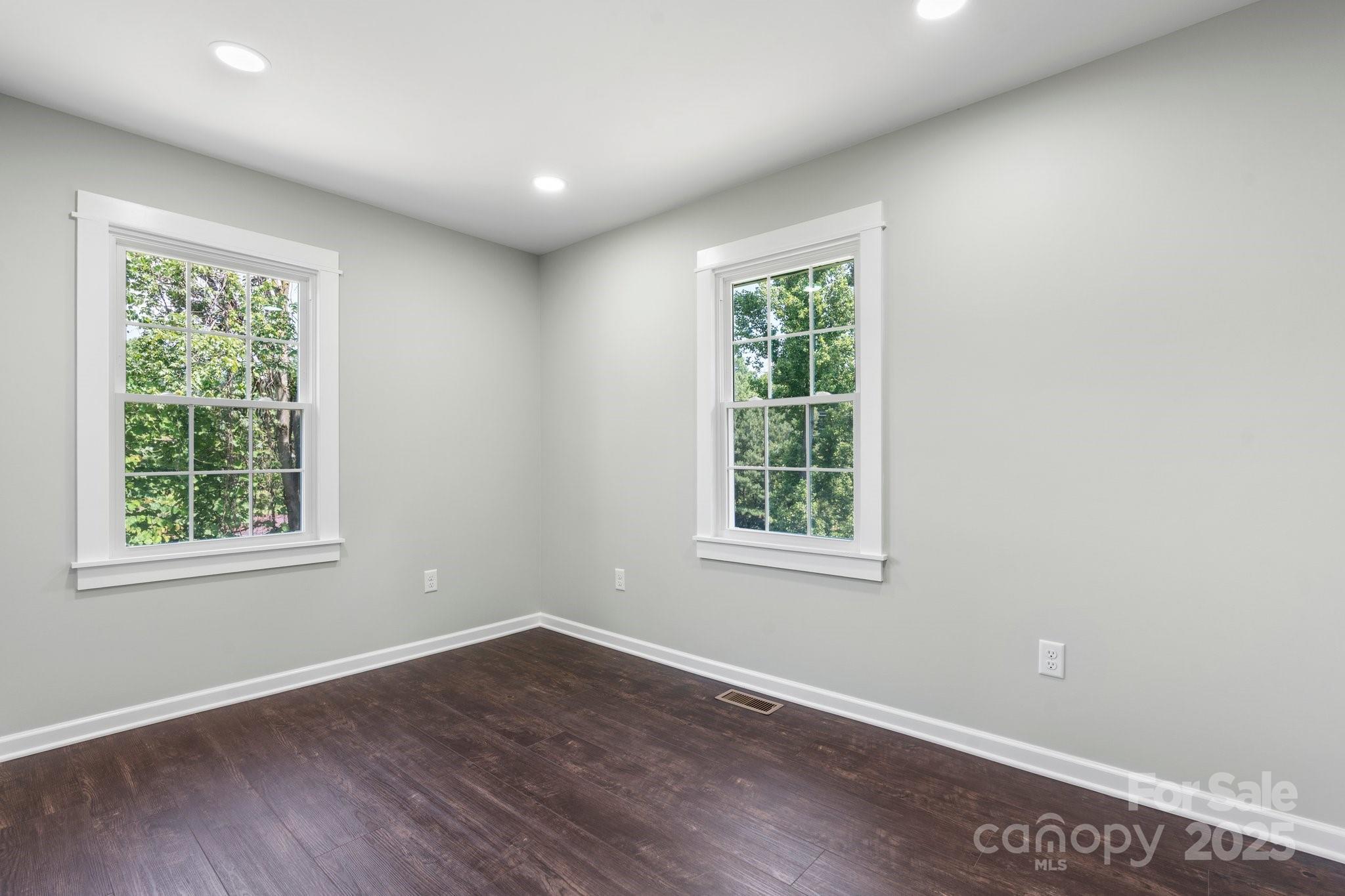 191 Harmony Grove Road Nebo, NC 28761 - Photo 28 of 47 an empty room with wooden floor and windows