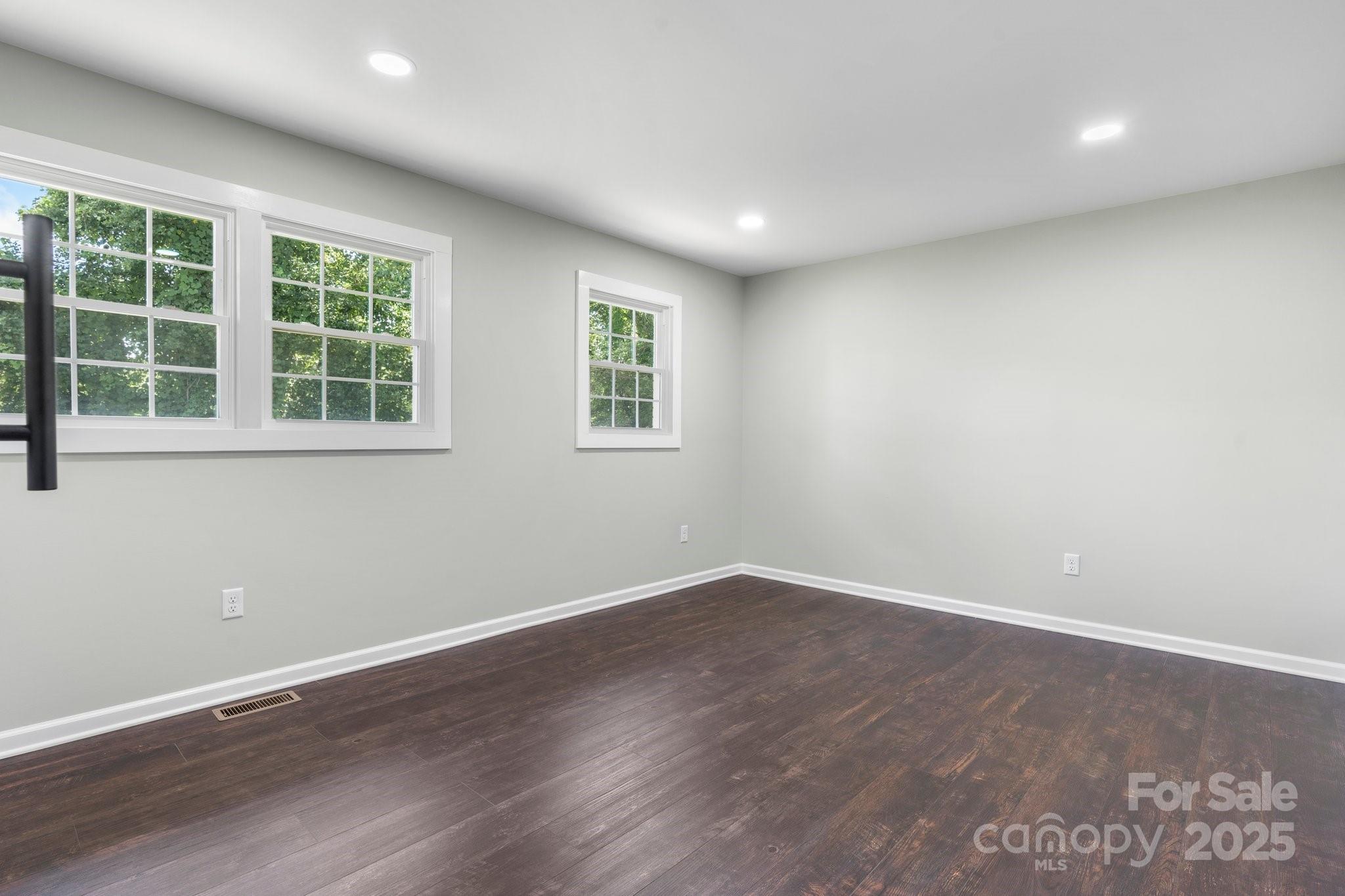 191 Harmony Grove Road Nebo, NC 28761 - Photo 30 of 47 an empty room with wooden floor and windows