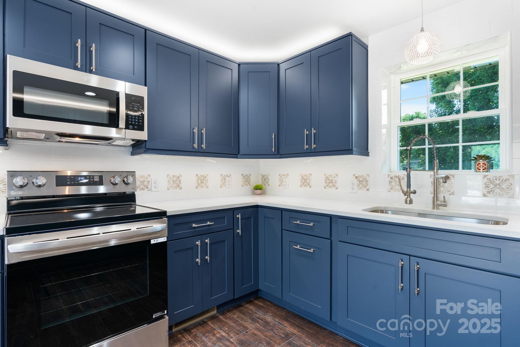 191 Harmony Grove Road Nebo, NC 28761 - Photo 41 of 47 a kitchen with wooden cabinets and a stove top oven