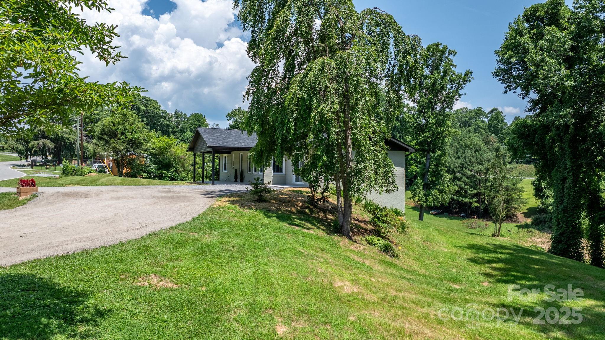 191 Harmony Grove Road Nebo, NC 28761 - Photo 5 of 47 a view of a garden with a bench and trees