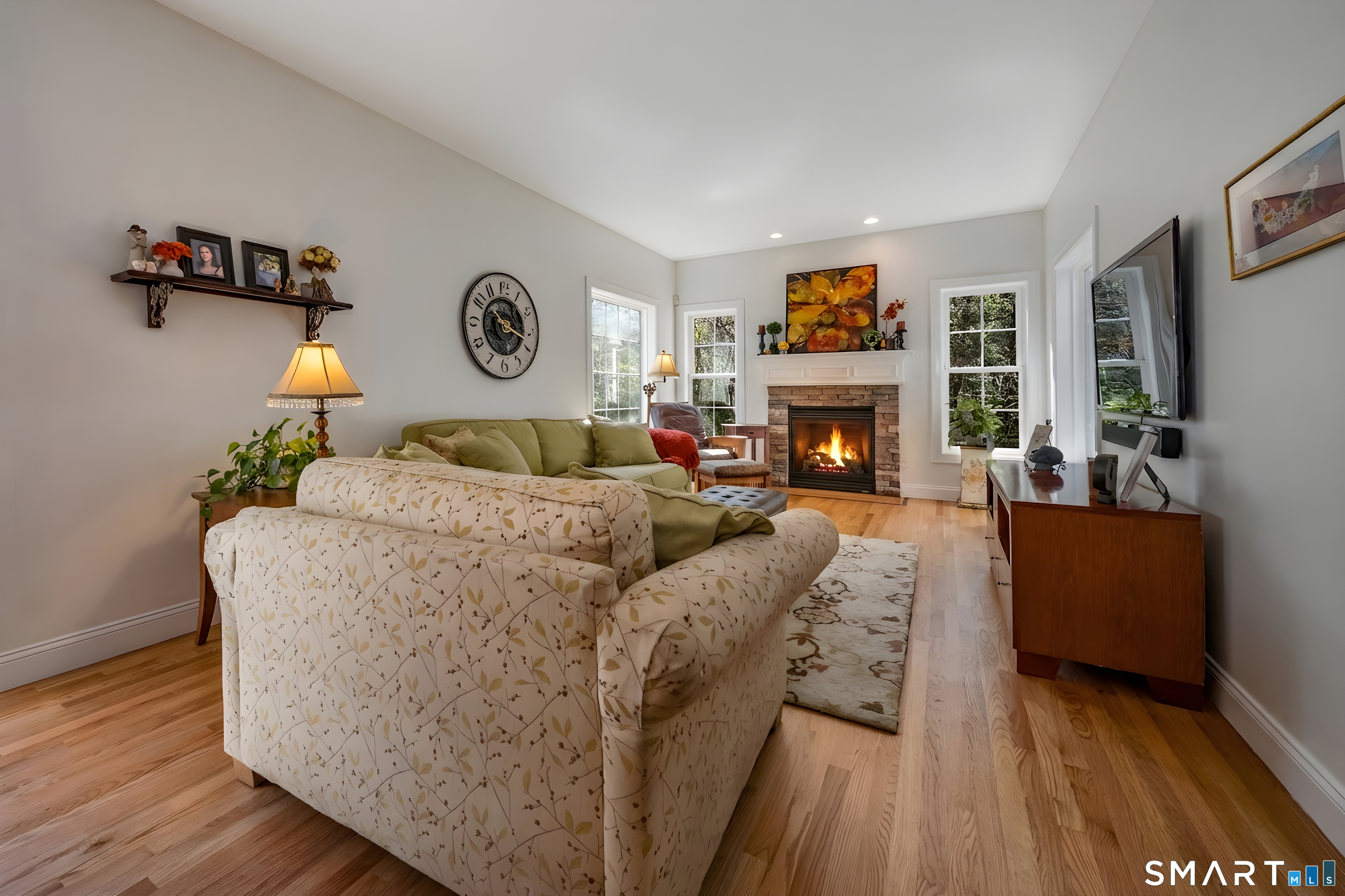 463 Tanner Marsh Road Guilford, CT 06437 - Photo 12 of 40 a living room with furniture and a fireplace