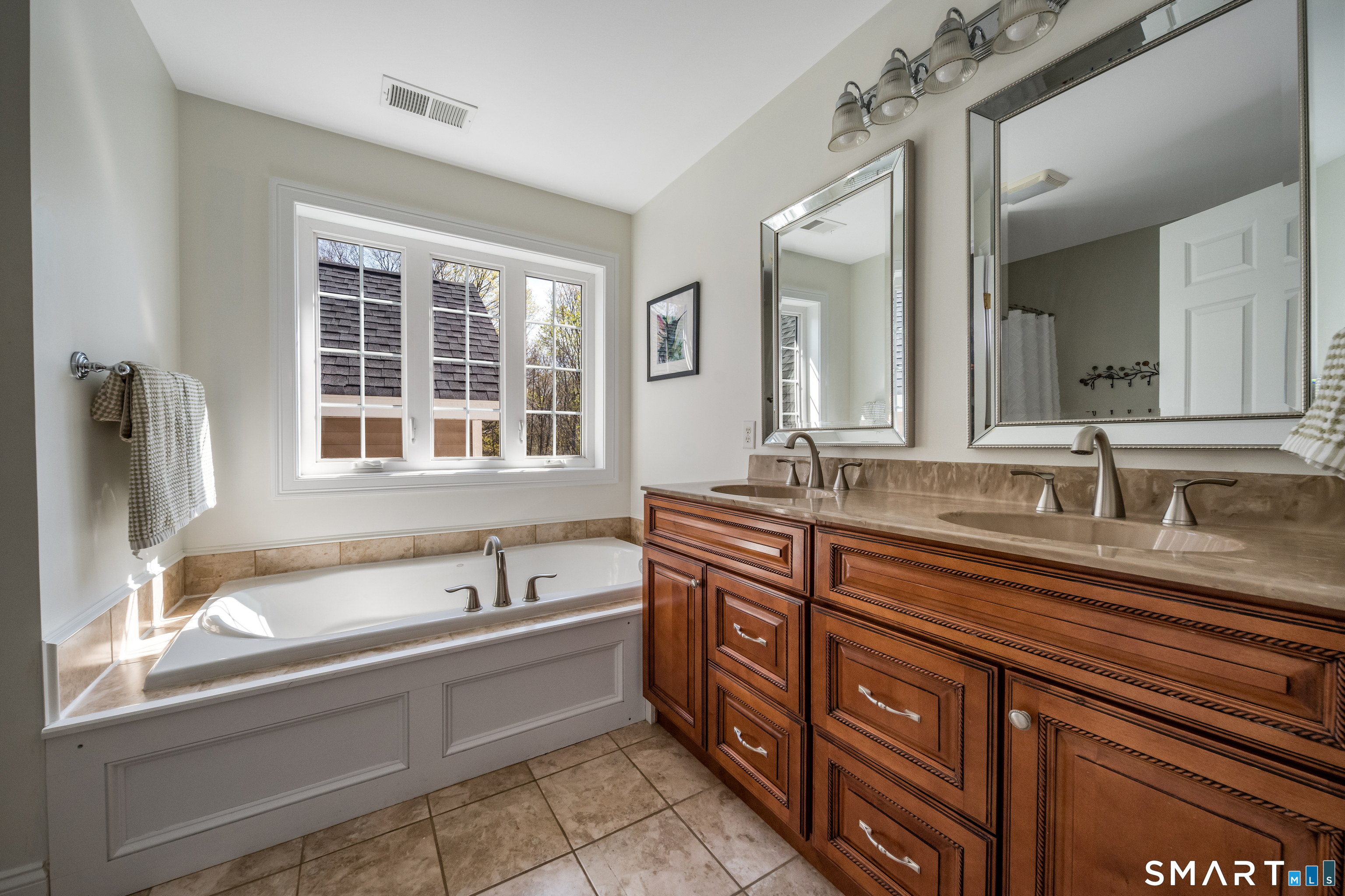 463 Tanner Marsh Road Guilford, CT 06437 - Photo 19 of 40 a spacious bathroom with a granite countertop sink and a bathtub