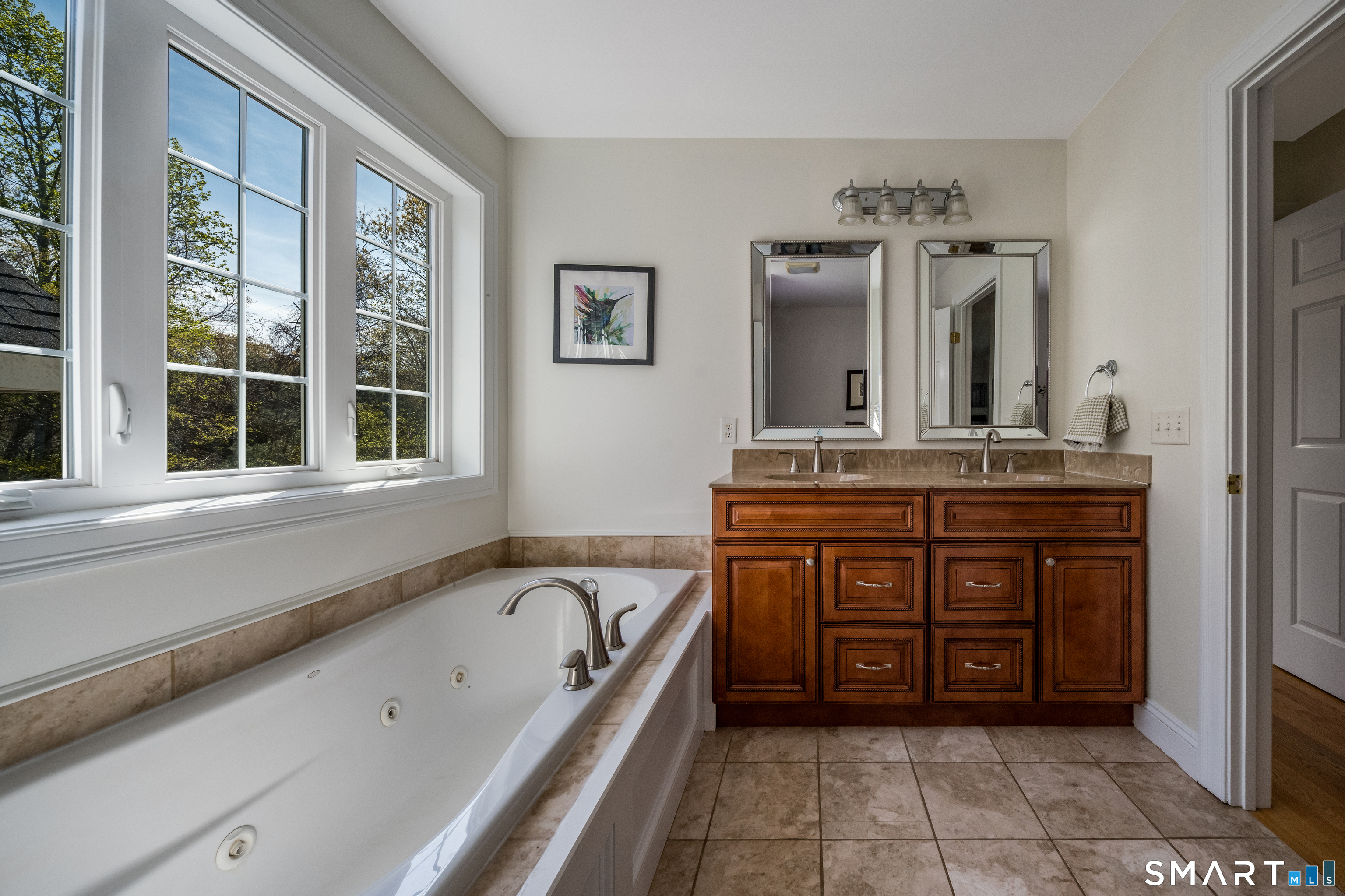 463 Tanner Marsh Road Guilford, CT 06437 - Photo 20 of 40 a bathroom with a tub sink and mirror