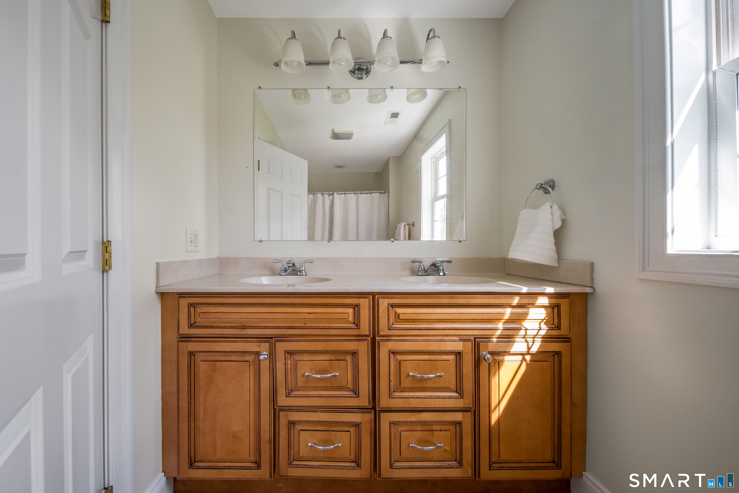 463 Tanner Marsh Road Guilford, CT 06437 - Photo 26 of 40 a bathroom with a sink and a mirror
