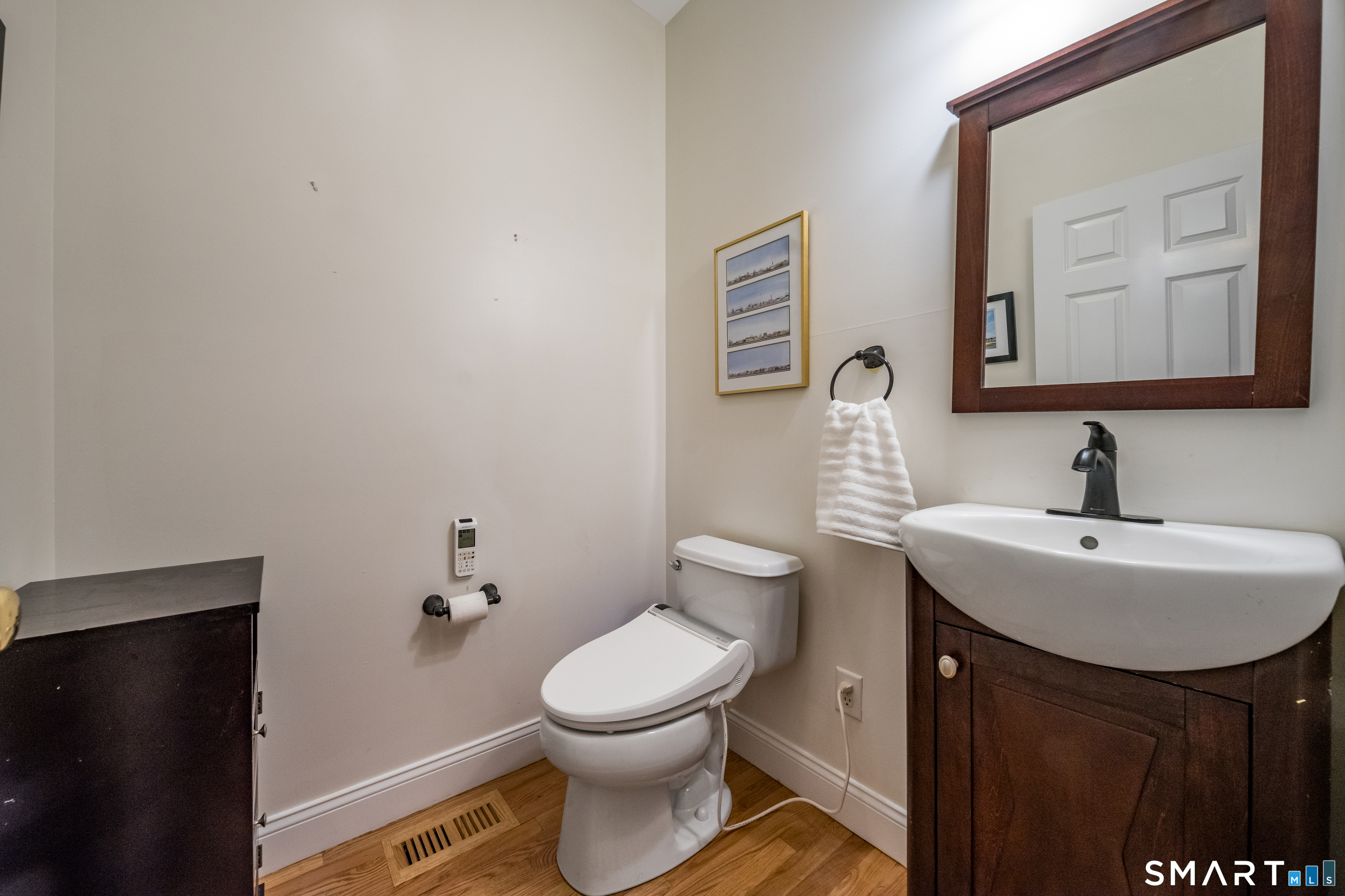 463 Tanner Marsh Road Guilford, CT 06437 - Photo 30 of 40 a bathroom with a toilet sink and mirror