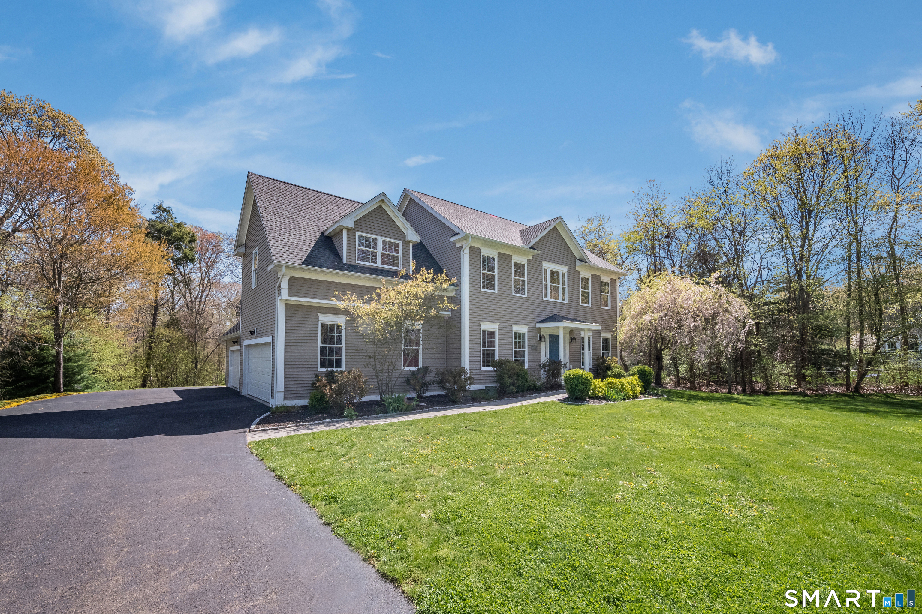 463 Tanner Marsh Road Guilford, CT 06437 - Photo 3 of 40 a view of a big house with a big yard and large trees