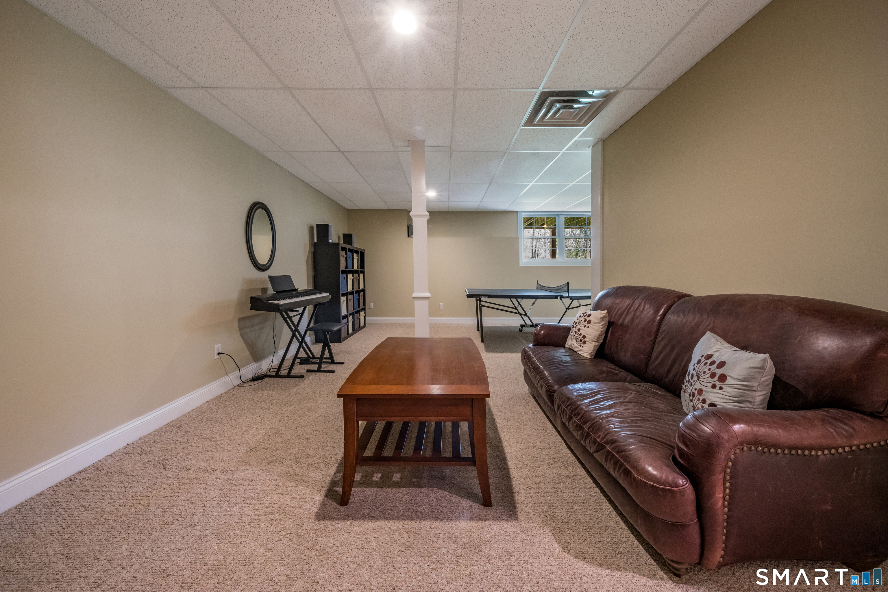 463 Tanner Marsh Road Guilford, CT 06437 - Photo 32 of 40 a living room with furniture a flat screen tv and a table