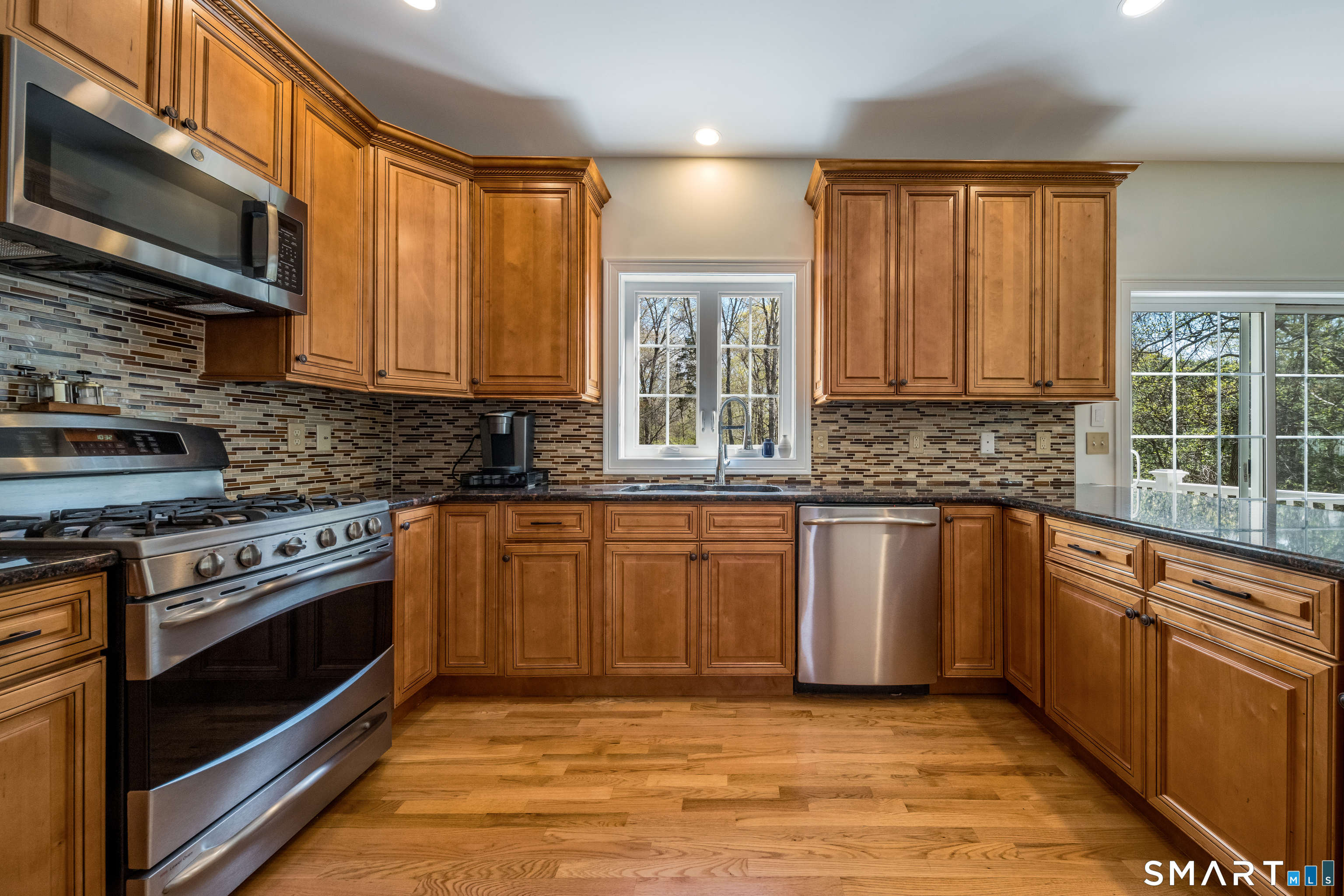 463 Tanner Marsh Road Guilford, CT 06437 - Photo 6 of 40 a kitchen with stainless steel appliances granite countertop a stove sink and microwave