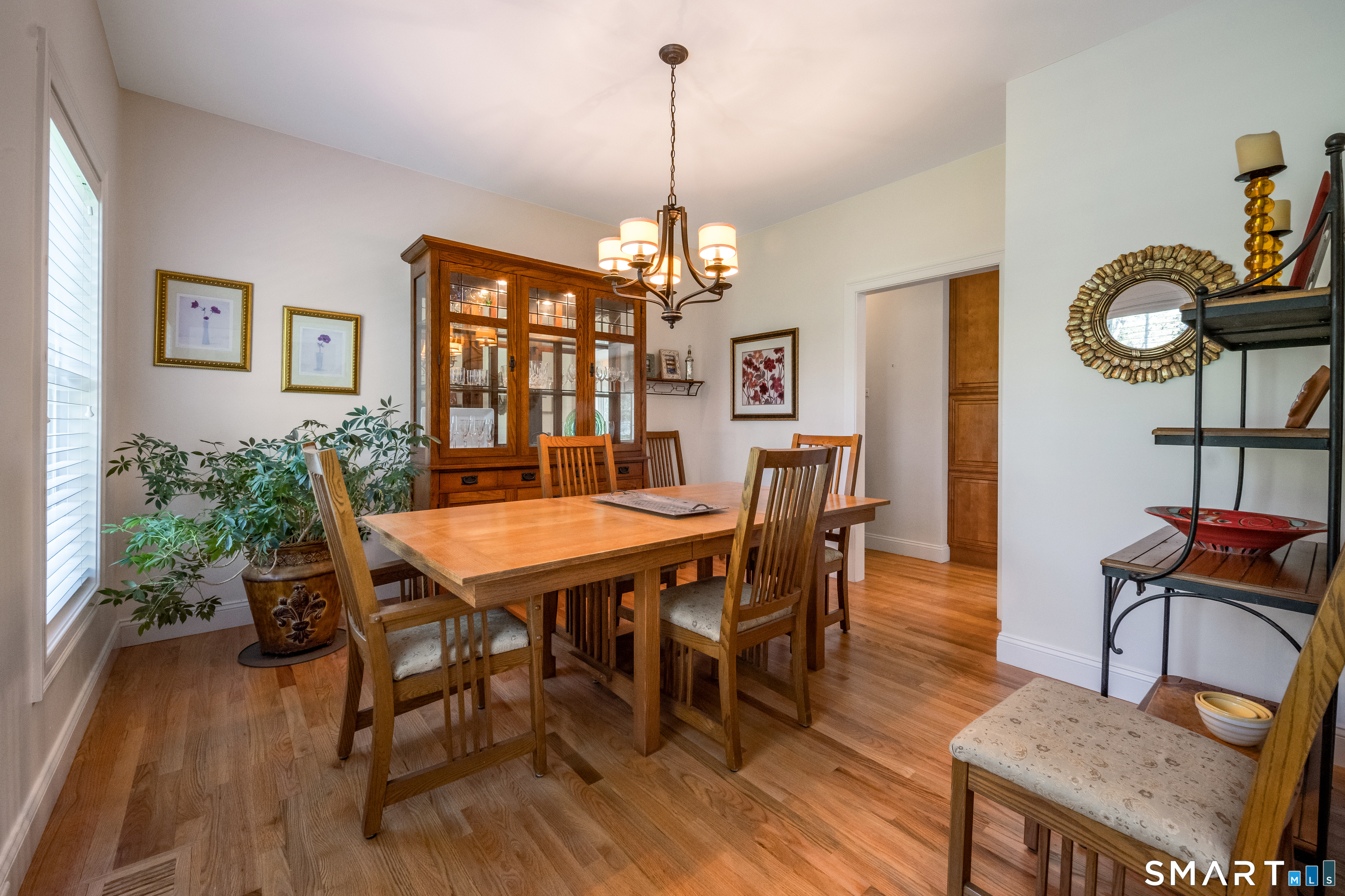 463 Tanner Marsh Road Guilford, CT 06437 - Photo 9 of 40 a dining room with furniture a chandelier and wooden floor