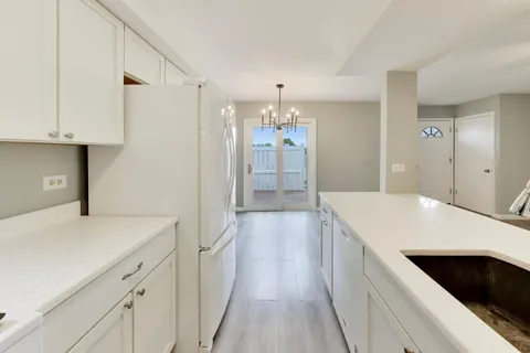 a view of a kitchen cabinets and wooden floor