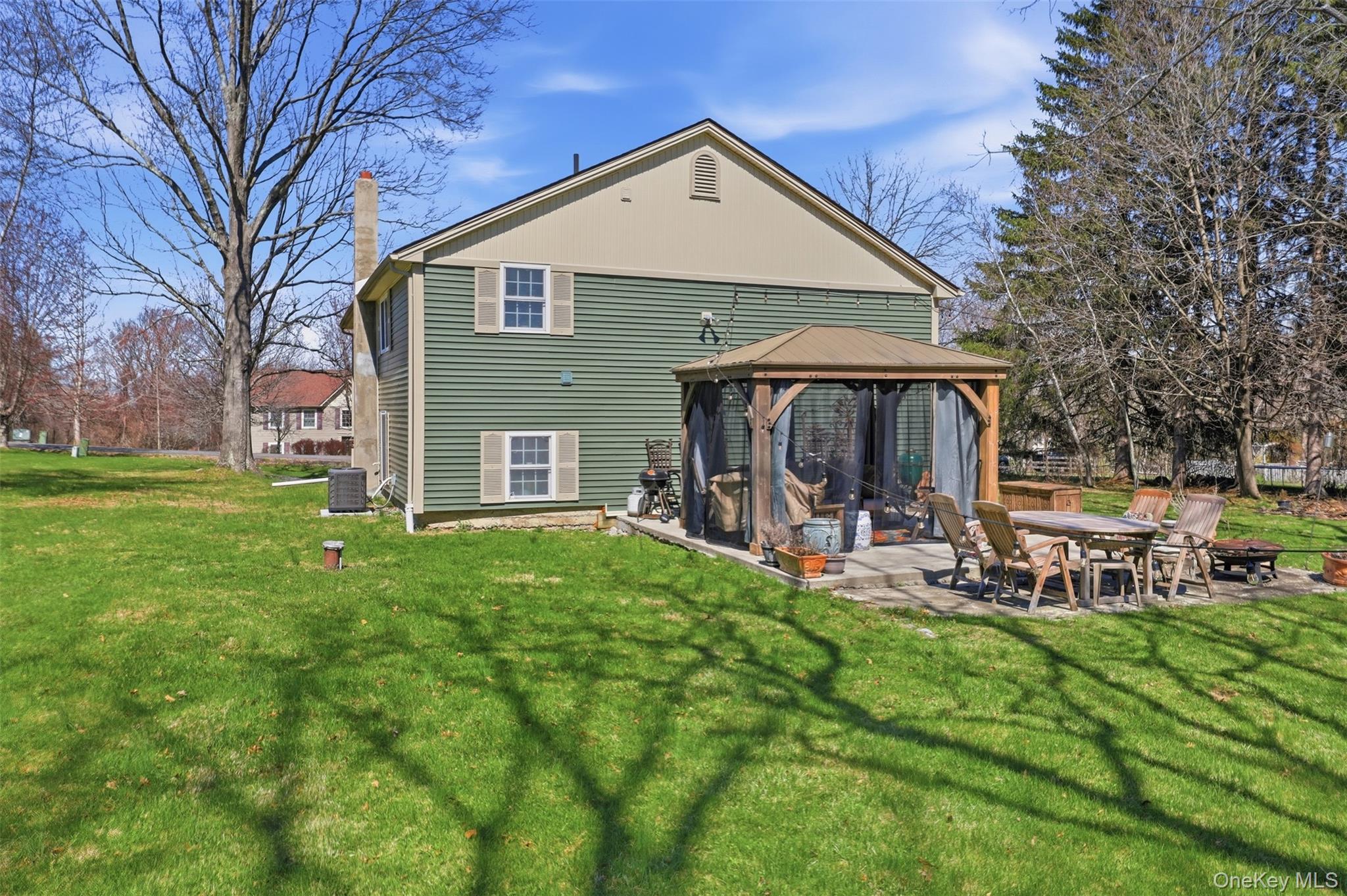 1 Lira Street Wallkill, NY 12589 - Photo 28 of 31 a front view of a house with a yard table and chairs