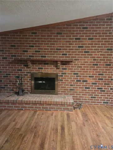 a view of empty room with a fireplace