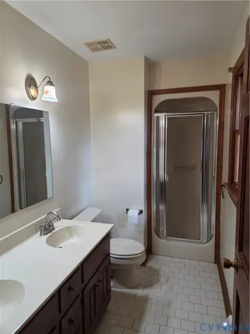 an empty room with wooden floor and closet area