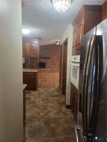 a kitchen with a refrigerator stove and cabinets