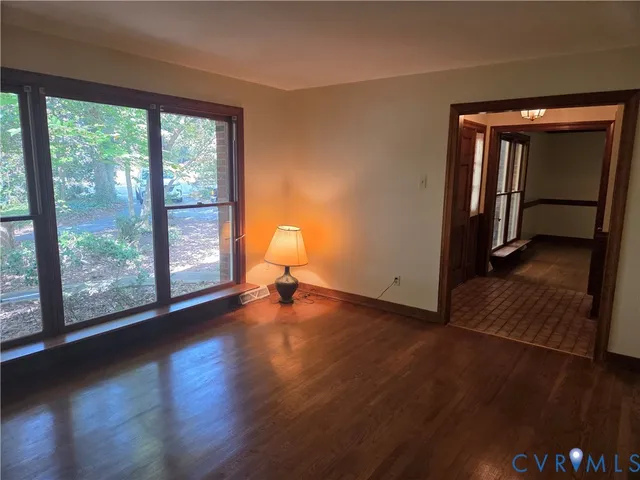 a view of a room with wooden floor and chandelier