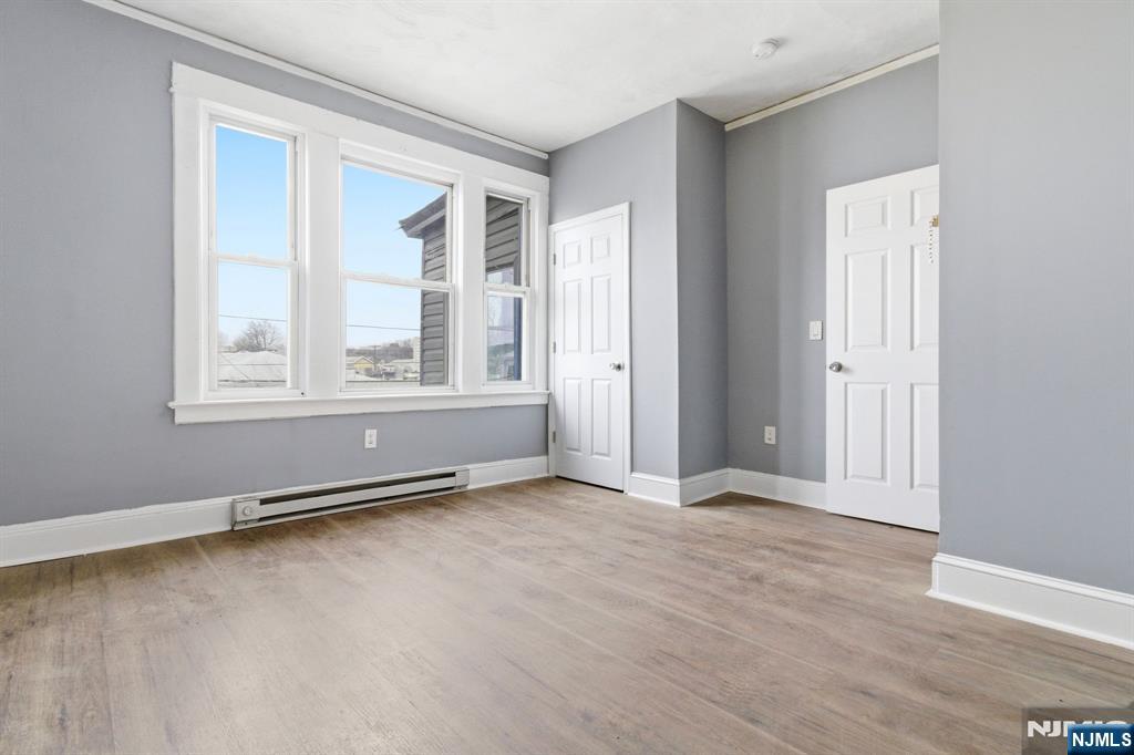 76 Grace Street Irvington, NJ 07111 - Photo 11 of 20 an empty room with wooden floor and windows