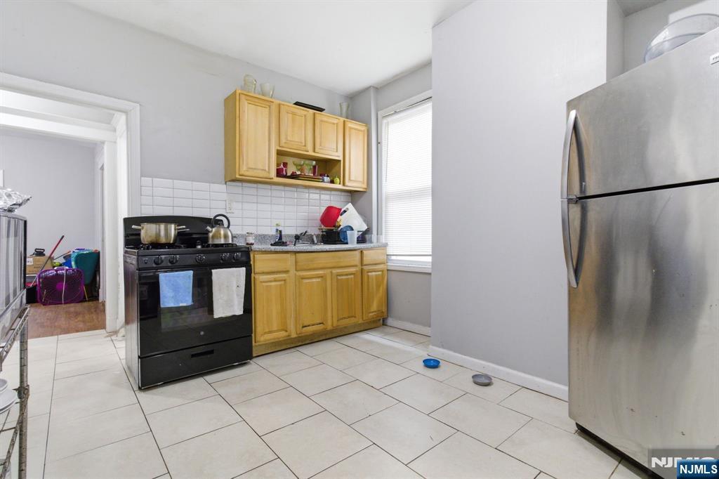 76 Grace Street Irvington, NJ 07111 - Photo 18 of 20 a kitchen with stainless steel appliances a refrigerator sink and stove