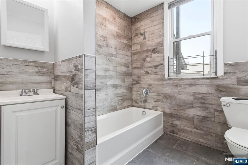76 Grace Street Irvington, NJ 07111 - Photo 20 of 20 a bathroom with a sink toilet and bathtub