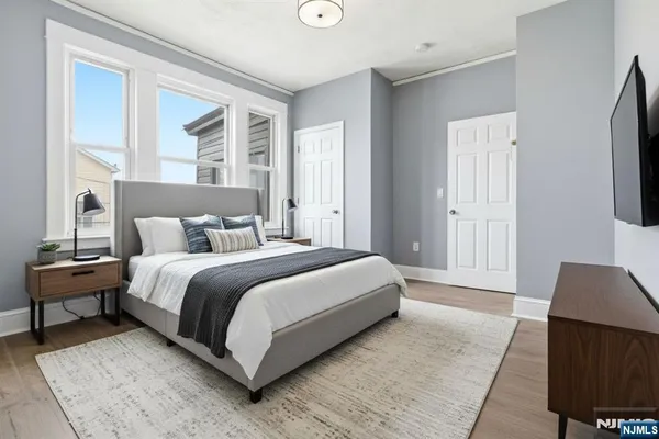 a bedroom with a bed and wooden floor