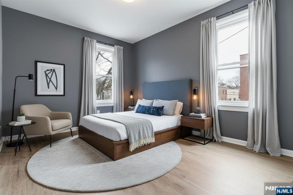 76 Grace Street Irvington, NJ 07111 - Photo 5 of 20 a spacious bedroom with a bed and wooden floor