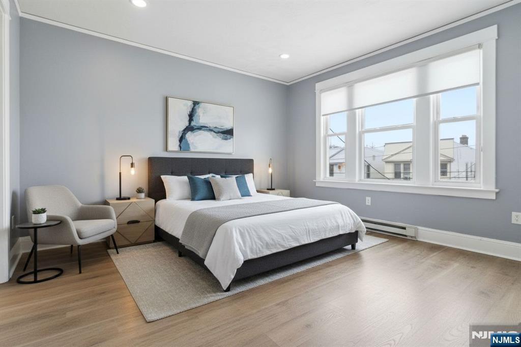 76 Grace Street Irvington, NJ 07111 - Photo 6 of 20 a bedroom with a bed and a large window