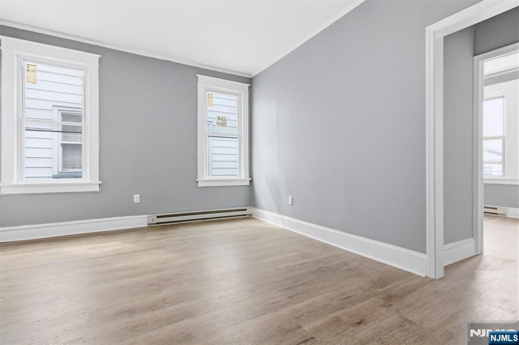 76 Grace Street Irvington, NJ 07111 - Photo 7 of 20 an empty room with wooden floor and windows